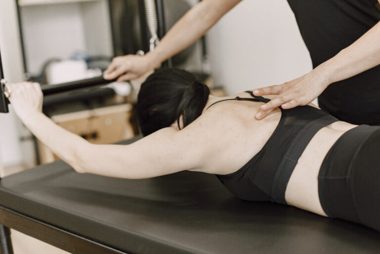 young woman streching muscles with a female traine 2022 06 09 15 38 02 utc