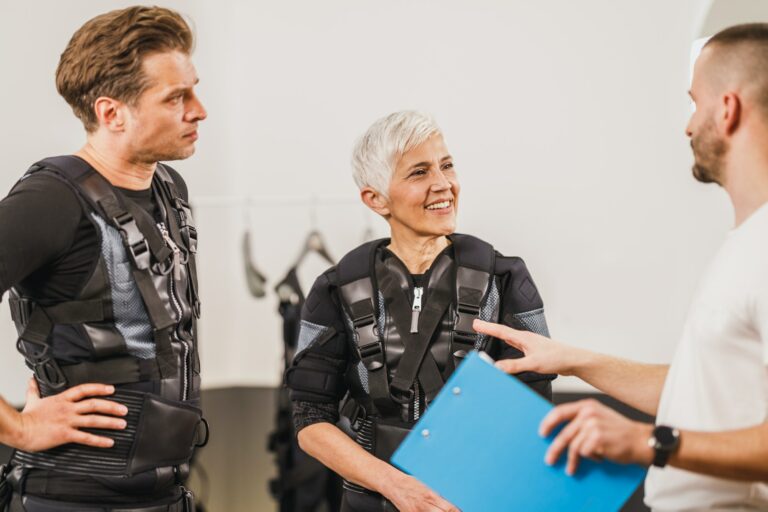 Couple Talking With Coach before EMS Training